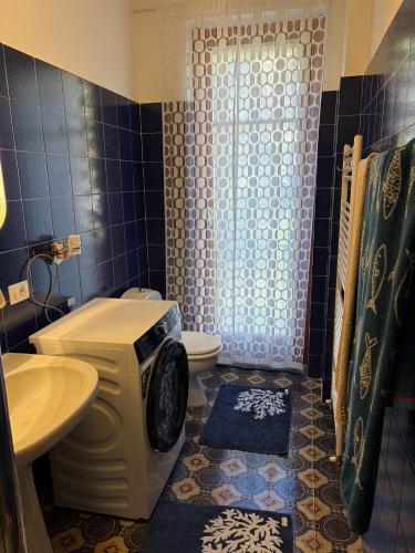 a bathroom with a toilet a sink and a shower at Lavinia in Oggebio