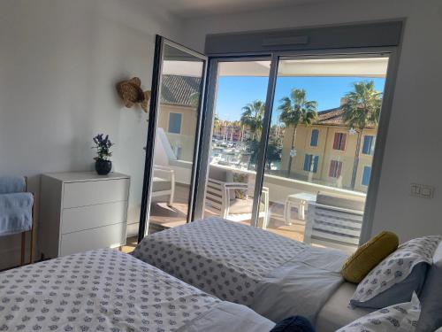 a bedroom with a bed and a view of a balcony at La Marina Sotogrande Pier2 in Torreguadiaro