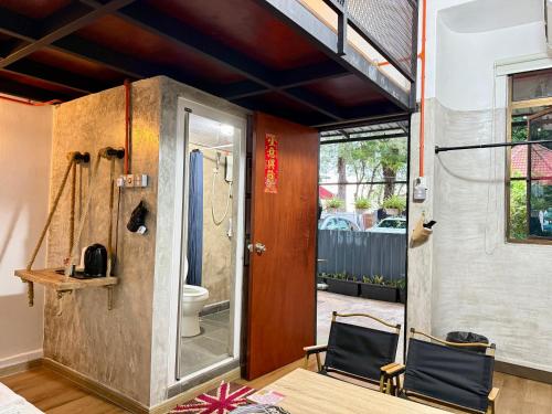 a bathroom with two chairs and a toilet in a room at Ardour Lodge "A" Wing in Tanjung Bungah