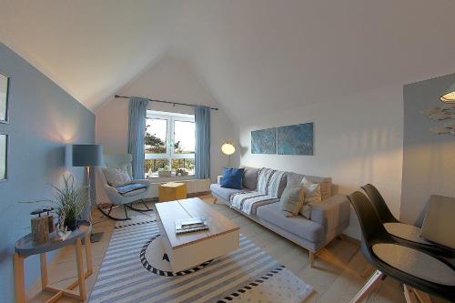 a living room with a couch and a table at Sie4-11 in Dorum-Neufeld