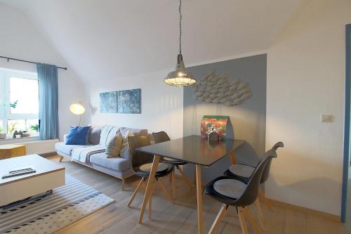 a living room with a table and a couch at Sie4-11 in Dorum-Neufeld