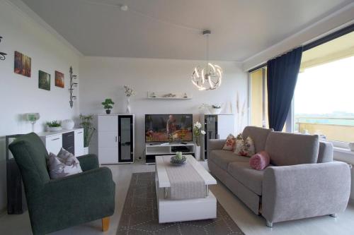 a living room with two couches and a tv at Apartment 256 in Hohegeiß