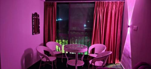 a purple room with a table and chairs at Soni & Avi View Apartment in Igatpuri
