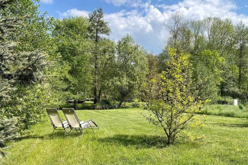 two chairs sitting in the grass in a field at Lokoschen in Lübbenau