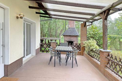 a patio with a table and chairs and a fireplace at Admiral in Lübbenau