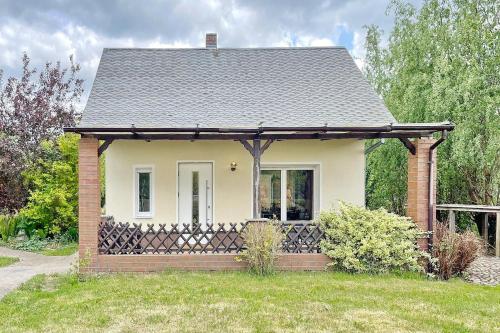 a small white house with a black roof at Admiral in Lübbenau