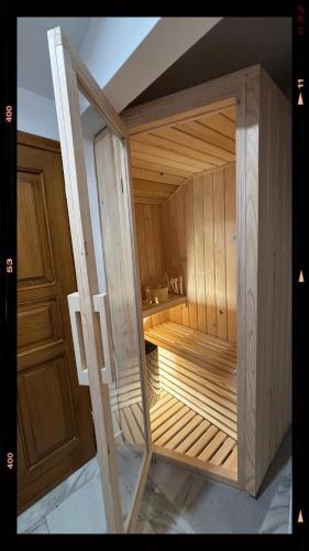 a wooden sauna with a wooden door in a room at Kuća za odmor Tina in Tounj