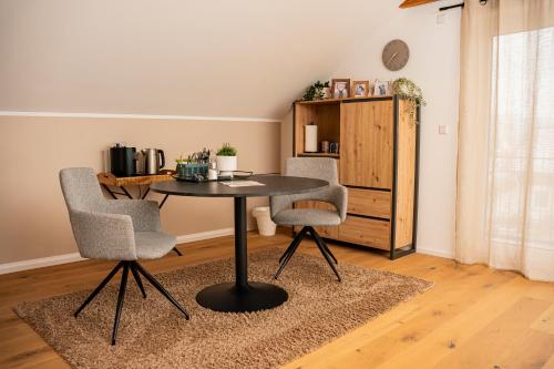 a table and two chairs in a room at Alb Appartement - gemütliche Wohnung mit Balkon in Balingen