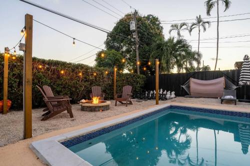 a backyard with a swimming pool and a fire pit at Hollywood Heated Pool Mini Golf Unique VR Room in Hollywood