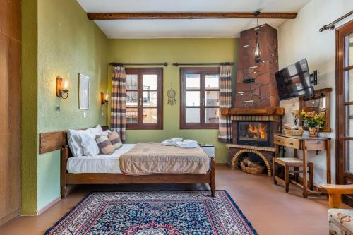 a bedroom with a bed and a fireplace at Rigas Hotel Arachova in Arachova
