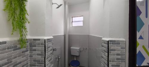 a bathroom with a urinal and a toilet at Tetiba Suite in Muar