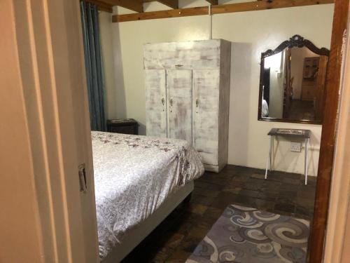 a bedroom with a bed and a large mirror at Best view family loft in Oranjeville