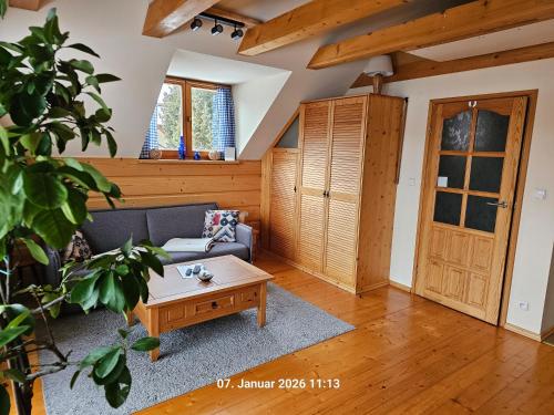 a living room with a couch and a coffee table at Ferienhaus Lipowa in Lipowa