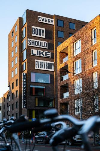 a building with a sign that reads every body should like everybody at The Social Hub Groningen Extended Stay in Groningen