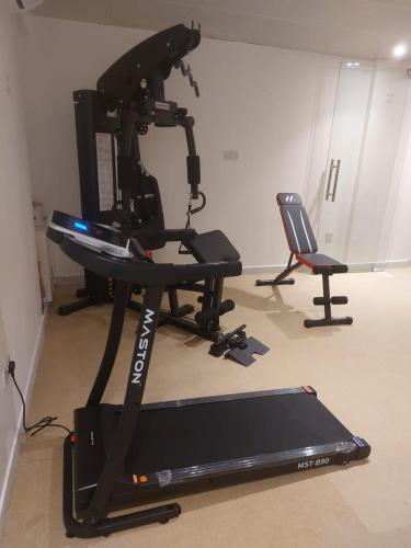 a camera on a stand in a room with a treadmill at HARF22-101-02 2br apt in AD in Abu Dhabi