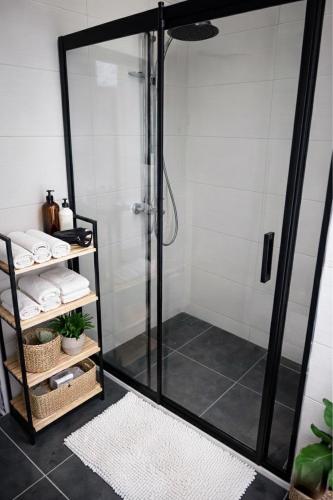 a shower stall with a glass door in a bathroom at Arsuz Suit in Hatay