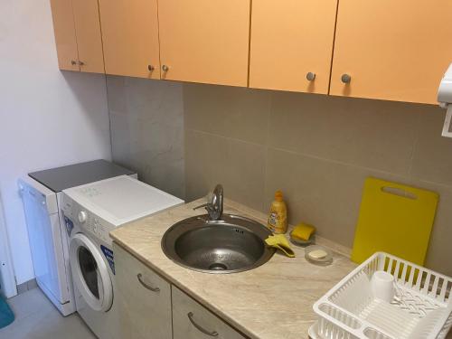 a kitchen with a sink and a washing machine at Apartments complex Breeze Sunny beach - Апартаменти комплекс Бриз Слънчев бряг in Sunny Beach