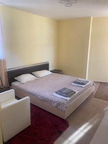 a bedroom with a bed and a chair at Apartments complex Breeze Sunny beach - Апартаменти комплекс Бриз Слънчев бряг in Sunny Beach