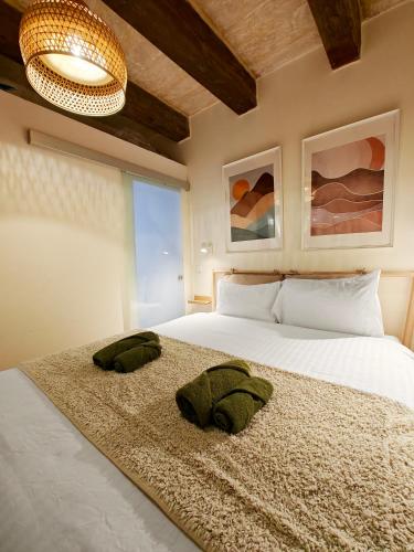 a bedroom with a bed with two pillows on it at Valletta Dome Apartment in Valletta