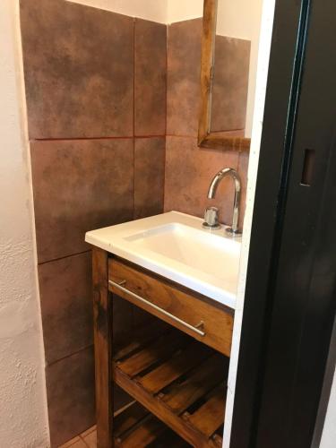 a bathroom with a sink and a mirror at Altos de Artalaz in Colón