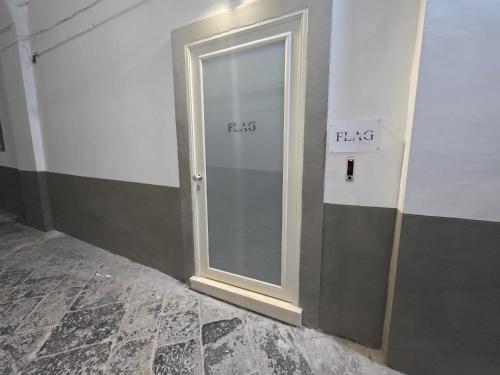 a sliding glass door in a room with the word fgas at Flag in Torre del Greco