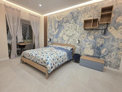 a bedroom with a bed with a floral wallpaper at Flag in Torre del Greco