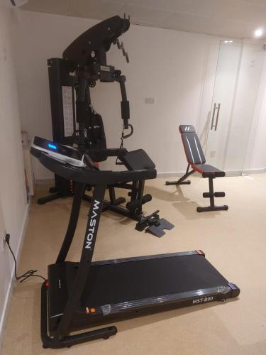 a camera on a stand in a room with a treadmill at HARF22-02 Peaceful 2BR in Abu Dhabi city in Abu Dhabi