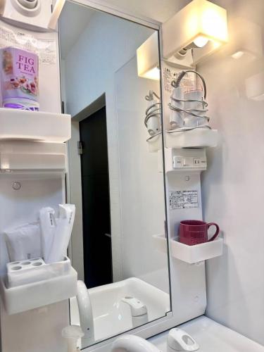 a bathroom with a mirror and a sink and a toilet at Mori de house in kobe 1 in Kobe