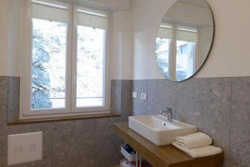 a bathroom with a sink and a mirror at LA FORESTERIA Case a Varese in Varese