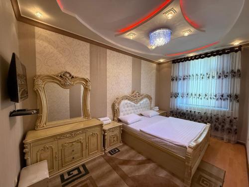 a bedroom with a large bed and a mirror at The Skyline Apartments in Samarkand