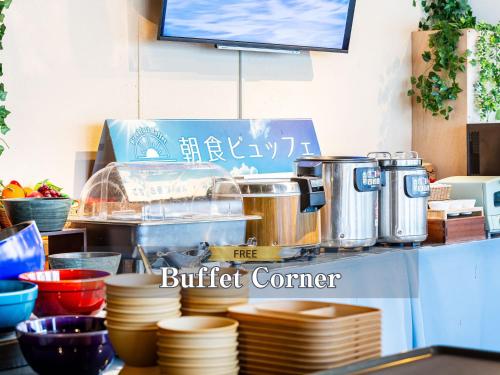 a buffet counter with pots and pans and plates at Hotel BaliAn Resort Kawasaki in Kawasaki