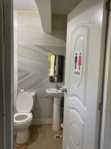 a bathroom with a toilet and a sink at Casa de Campo Vive in Ensanche Savica de Mendoza