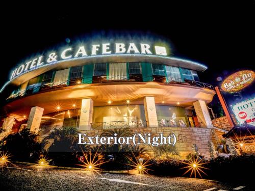 a building with a sign that reads hotel and cafe bar at Hotel BaliAn Resort Kawasaki in Kawasaki