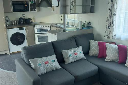 a blue couch with pillows on it in a kitchen at Lodge - Sleeps 6 with Pool Access in Hastings
