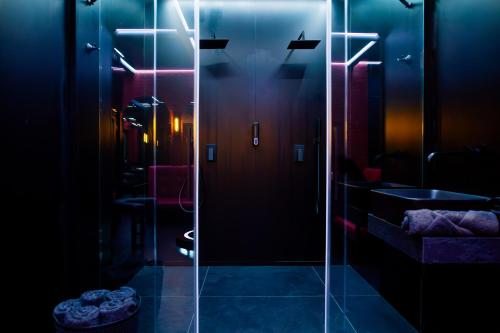 a glass shower door in a bathroom with a sink at Love Apartament z sauną i jacuzzi in Katowice
