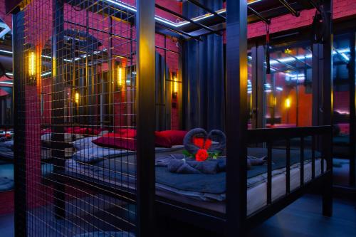 a room with two beds in a cage with a stuffed animal at Love Apartament z sauną i jacuzzi in Katowice