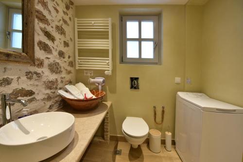a bathroom with a sink and a toilet at Sterna Apartment in Hydra