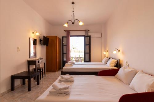 a hotel room with two beds and a couch at Casa di Dandolo in Parga