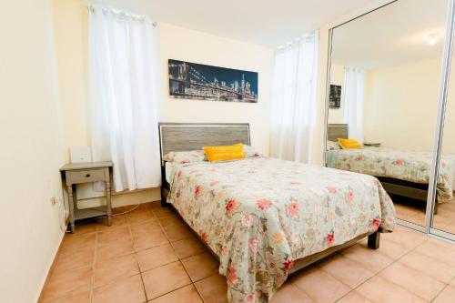 a bedroom with two beds and a mirror at Beach condo with 3 bedrooms and ocean views in Rio Grande