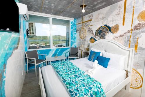 a bedroom with a bed and a wall with a map at Ocean view condo with pool & fits 3 in Fajardo