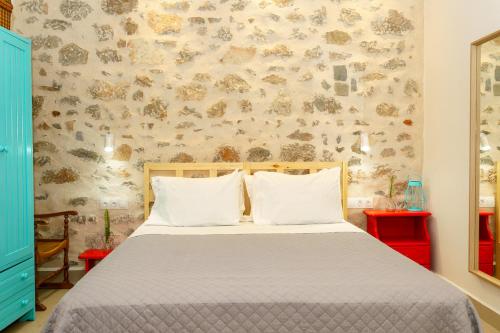 a bedroom with a bed with two pillows at Ydor apartment in Hydra