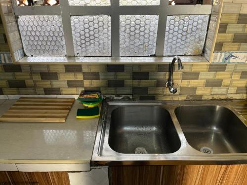 a kitchen counter with a sink in a kitchen at Golf BnB in Nyahururu