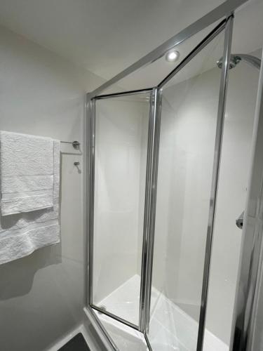 a shower with a glass door in a bathroom at Stay at St Marks in Lincoln