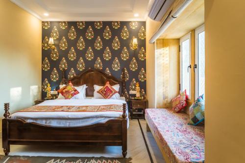 a bedroom with a bed and a black wall at The Rising Haveli in Jaisalmer