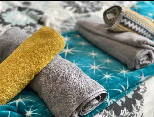 a pair of towels sitting on top of a bed at Central Southsea Studio, Perfect for work or Leisure, Central, Parking, self check-in, modern and comfortable in Portsmouth