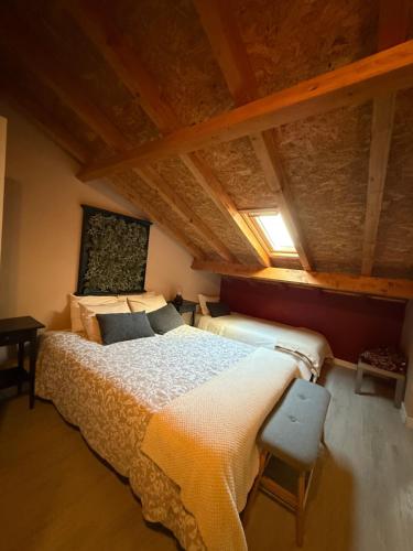 a bedroom with a large bed in an attic at Casa Do Campo in Peniche