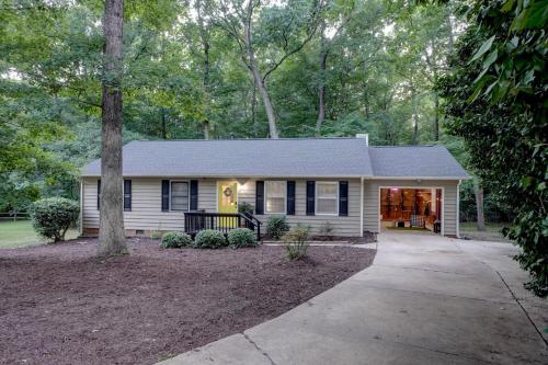 a white house with black windows and a driveway at Downtown Guest House in Raleigh