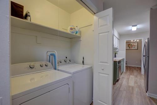 a white kitchen with white appliances and a refrigerator at Downtown Guest House in Raleigh