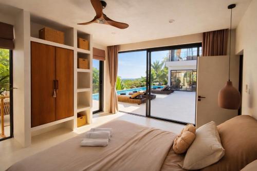 a bedroom with a large bed and a large window at Villa Nomada Exclusive Modern Seaview Spa and Wellness Villa with Daily Housekeeping 5 Bedrooms Sauna Ice Bath and 20 Meter Private Saltwater Pool in Ban Bang Po