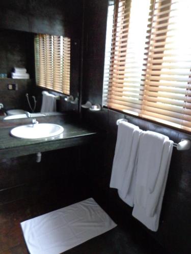 a bathroom with a sink and a white towel at Paradise Beach Club in Mirissa